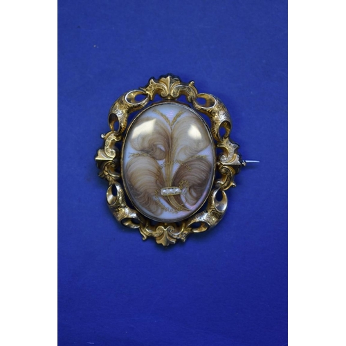 83 - A large Victorian unmarked gold memento mori brooch, both sides showing coiled hair, pearl and gold ... 