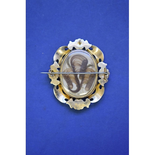 83 - A large Victorian unmarked gold memento mori brooch, both sides showing coiled hair, pearl and gold ... 