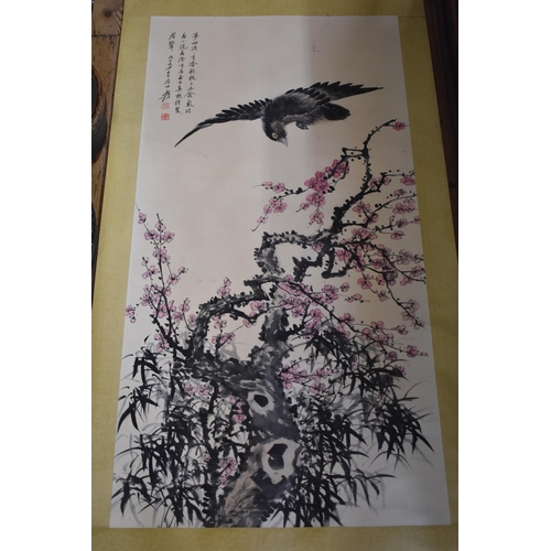 672 - Chinese School, a bird with flowering prunus, watercolour scroll, 134 x 67cm.