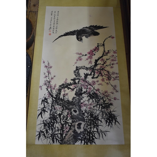 672 - Chinese School, a bird with flowering prunus, watercolour scroll, 134 x 67cm.