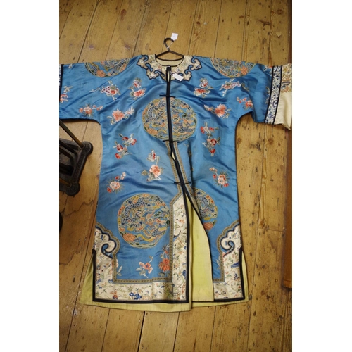 666 - A Chinese blue silk ladies jacket, embroidered with Peking Knot and decorated with dragons and phoen... 