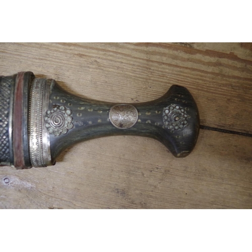 1870 - An eastern horn handled jambiya and metal mounted leather sheath; together with another similar east... 