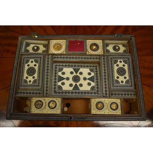 1410 - A 19th century Vizagapatam sewing casket, the interior lid panel painted with a watercolour lan... 