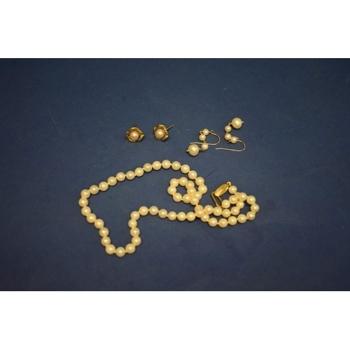 149 - A string of cultured pearls having 9ct gold clasp; together with two pairs of unmarked pearl earring... 