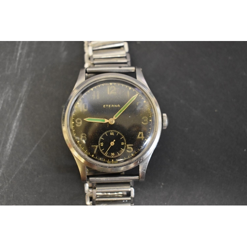 121 - A WWII Eterna Jumbo military style gentlemans wristwatch, black dial with gold Arabic numerals, gree... 