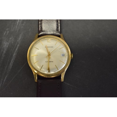 123 - A Garrard 9ct gold gentlemans automatic wristwatch, hallmarked London 1974, 34mm case, on leather st... 