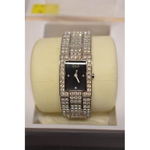 141 - A boxed ladies Guess wristwatch; together with a boxed Dolce et Gabbana ladies wristwatch; and a box... 