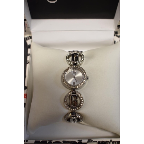 141 - A boxed ladies Guess wristwatch; together with a boxed Dolce et Gabbana ladies wristwatch; and a box... 