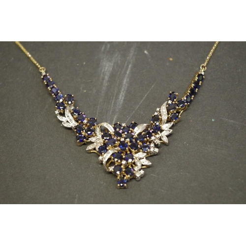 147 - An 18ct gold sapphire and diamond encrusted necklace.