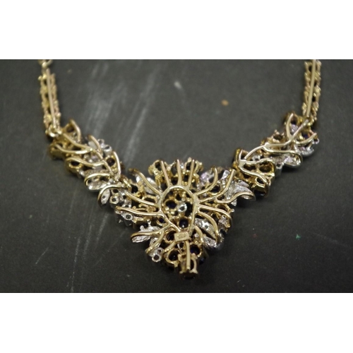 147 - An 18ct gold sapphire and diamond encrusted necklace.