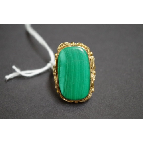 156 - A yellow metal ring set large rectangular malachite.