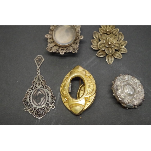 168 - A Victorian filigree mourning brooch; together with two other similar examples; and two pendants, (5... 