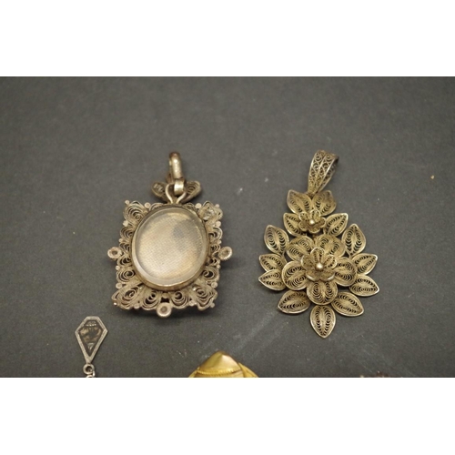 168 - A Victorian filigree mourning brooch; together with two other similar examples; and two pendants, (5... 