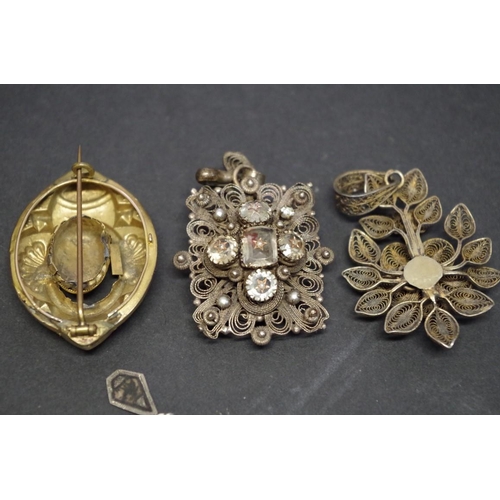 168 - A Victorian filigree mourning brooch; together with two other similar examples; and two pendants, (5... 