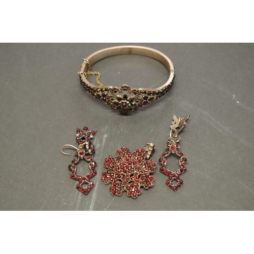 173 - A small group of Victorian garnet set jewellery; comprising; a bangle; a pendant; and a pair of drop... 