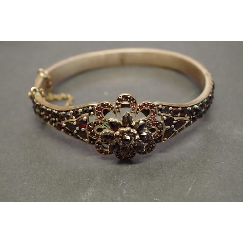 173 - A small group of Victorian garnet set jewellery; comprising; a bangle; a pendant; and a pair of drop... 