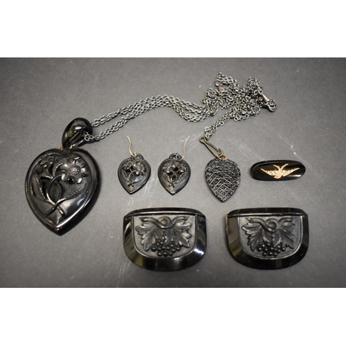 180 - A large Victorian carved jet heart pendant and matching earrings; together with a French jet brooch ... 