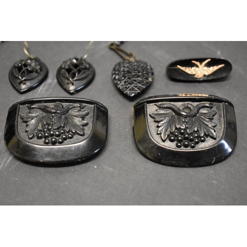 180 - A large Victorian carved jet heart pendant and matching earrings; together with a French jet brooch ... 