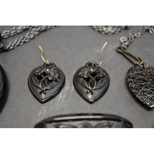 180 - A large Victorian carved jet heart pendant and matching earrings; together with a French jet brooch ... 