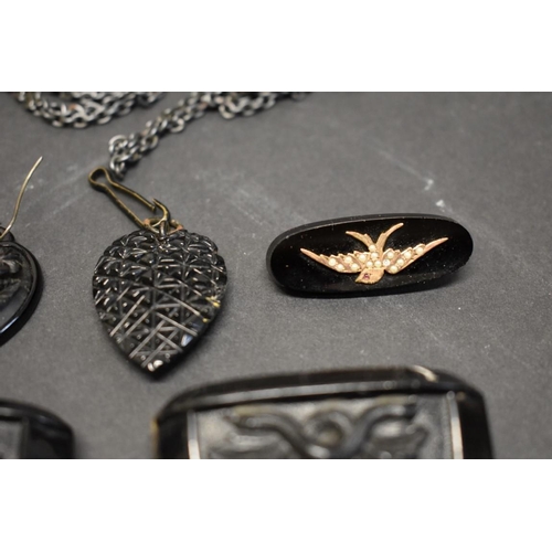 180 - A large Victorian carved jet heart pendant and matching earrings; together with a French jet brooch ... 