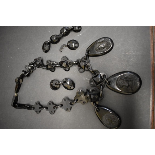 182 - A large Victorian jet necklace, have three carved cameo pendants, (a/f).