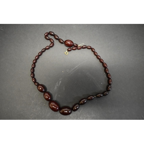 184 - A string of graduated cherry amber style beads, 57cm, 35.5g