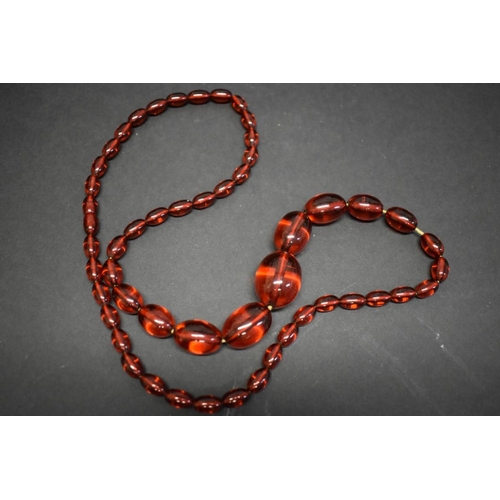 189 - A string of graduated cherry amber style beads, 76cm, 60.3g