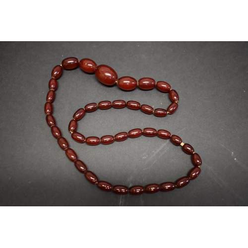 190 - A string of graduated cherry amber style beads, 62cm, 36.3g