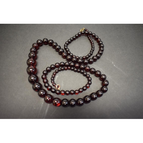 193 - A string of graduated cherry amber style beads, 90cm, 48g