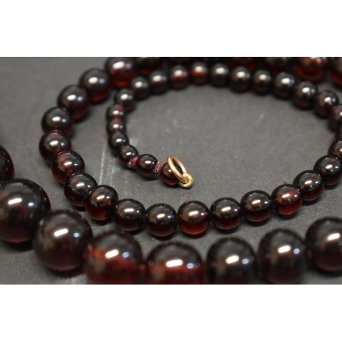 193 - A string of graduated cherry amber style beads, 90cm, 48g