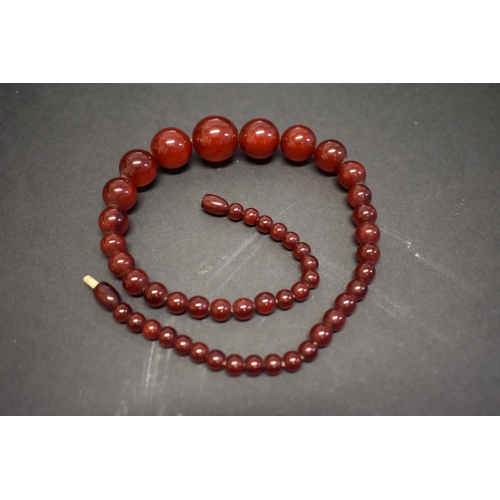 194 - A string of cherry amber style beads, 45cm, 34.5g