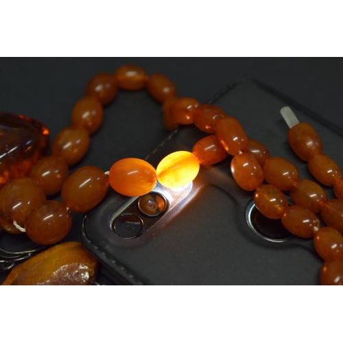 197 - A string of graduated toffee amber style beads, 48cm, 16.5g; together with a chunky freeform butters... 