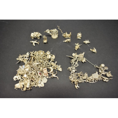 200 - A quantity of silver charm bracelets and loose charms, 222g total weight.