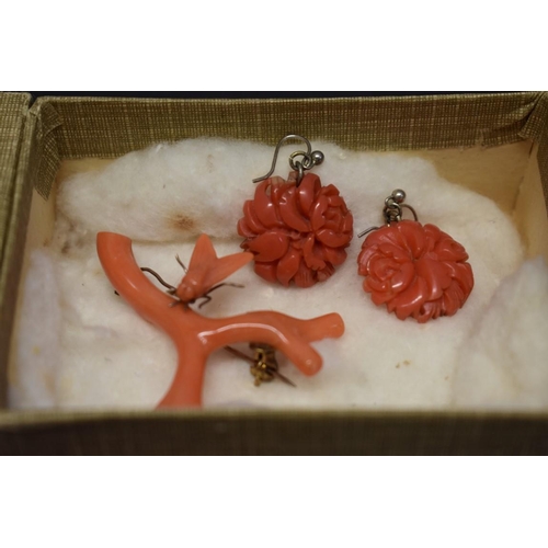 201 - An antique carved coral chain having reclining cherub clasp; together with two other items of carved... 