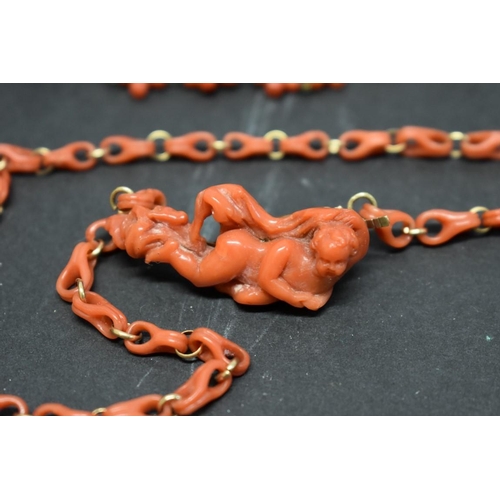 201 - An antique carved coral chain having reclining cherub clasp; together with two other items of carved... 