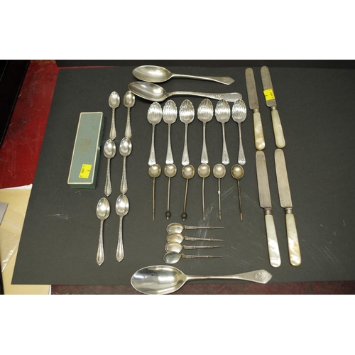 80 - A quantity of silver teaspoons; together with four mother of pearl handled silver knives; and three ... 