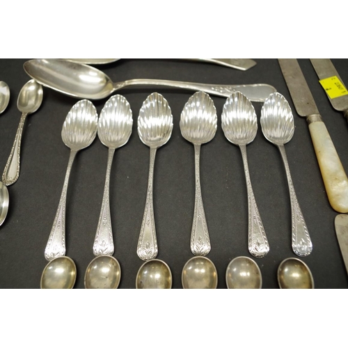 80 - A quantity of silver teaspoons; together with four mother of pearl handled silver knives; and three ... 