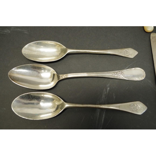 80 - A quantity of silver teaspoons; together with four mother of pearl handled silver knives; and three ... 