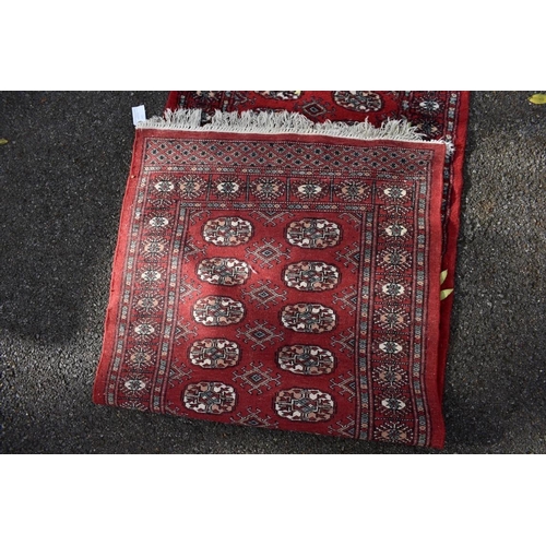 1197 - A modern Bokhara runner; together with a Chinese runner and one other Chinese rug.... 