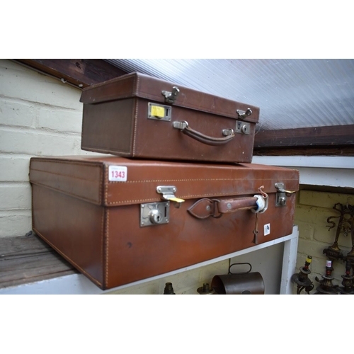 1343 - A vintage brown leather suitcase, by Finnigans 65cm wide; together with another smaller example.... 