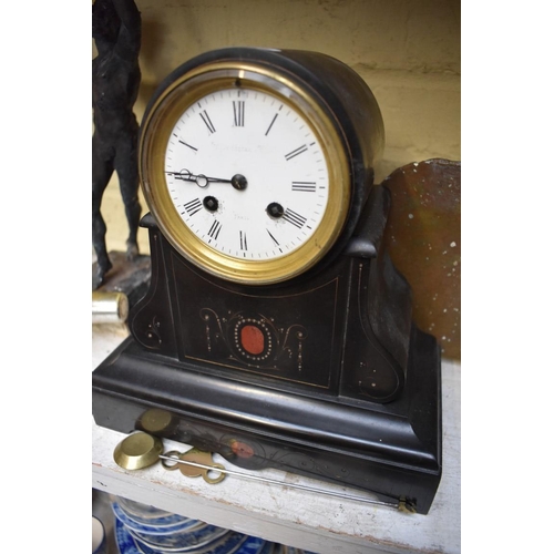 1368 - A slate clock, 27cm high, with pendulum. 