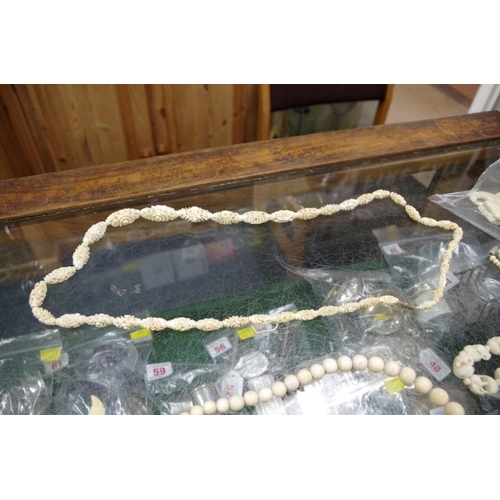 214 - A quantity of carved ivory jewellery to include; necklaces and brooches etc.