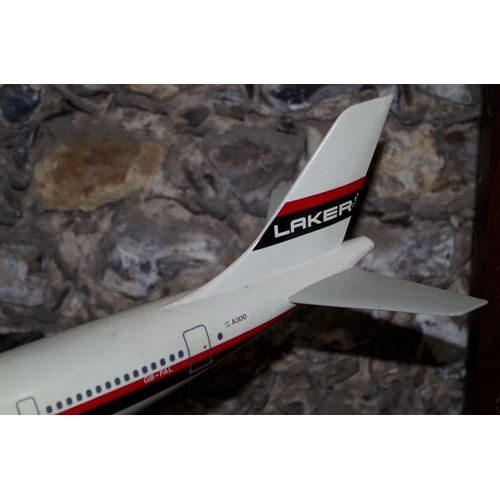 1057 - A model of a Laker A300 'Skytrain' aeroplane, wingspan 46cm, on stand.