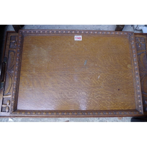 1143 - A carved oak twin handled rectangular tray, 65.5cm wide; together with another smaller rectangu... 