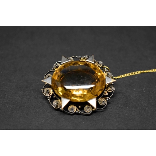 117 - An filigree oval citrine brooch, total weight 17.5g.