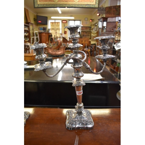 194 - A pair of Georgian style silver plated candlesticks, 33cm; together with a similar plated candelabra... 