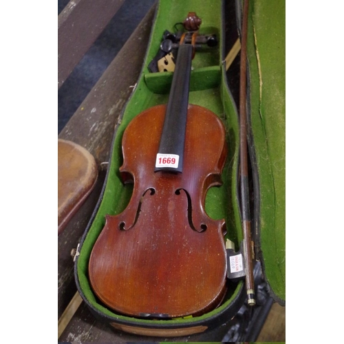 1669 - An antique Continental violin, with Stradivarius label, and 13in back, with associated case and bow.... 