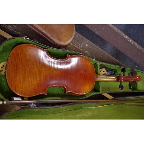 1669 - An antique Continental violin, with Stradivarius label, and 13in back, with associated case and bow.... 