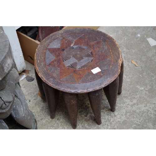 1050A - Ethnographica: two tribal figural stools, largest 51cm high; together with another multi leg stool; ... 