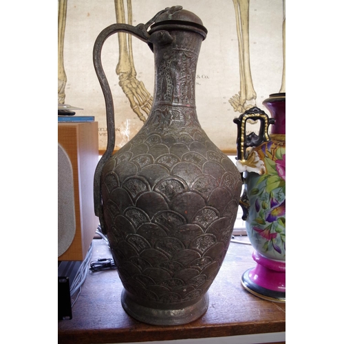 1176 - A large Islamic silvered copper jug, 55cm high; together with three others.